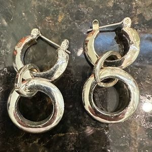 Silver tone dangling hoops.